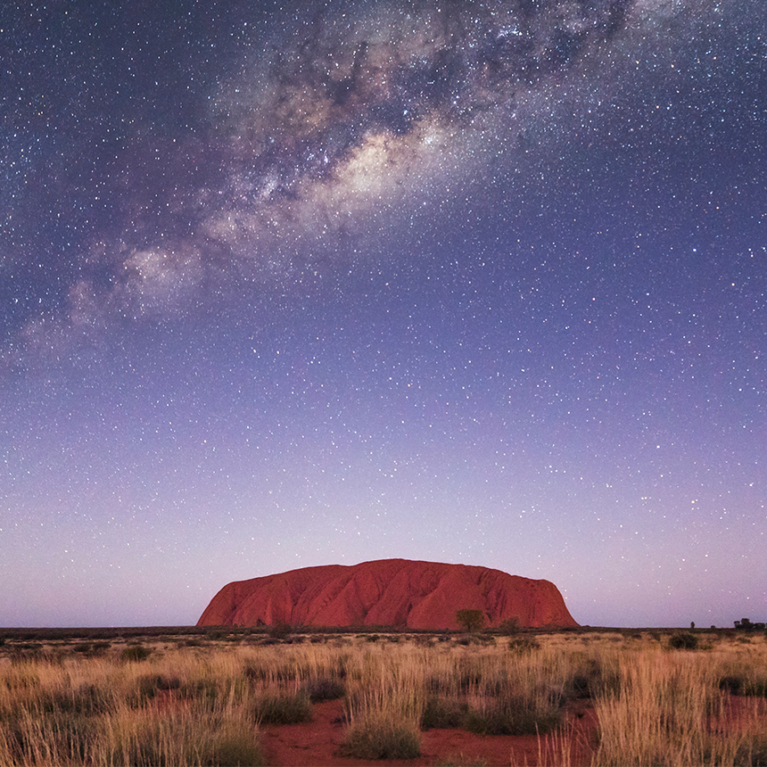 Uluru rock in Australia under milky way